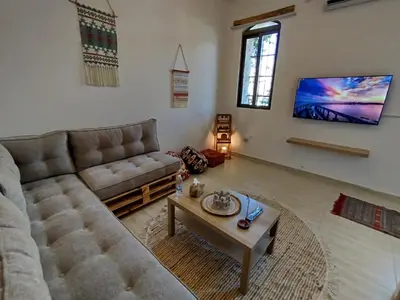 a living room with a couch and a coffee table at Cozy Apt in amman with a view in Amman