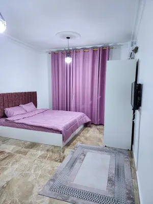 a bedroom with a bed and purple curtains at Salo StudioS in Amman