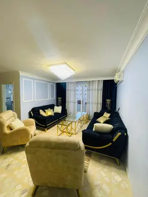 a living room with two couches and a couch at Cozy 2 bedroom apartment in Amman