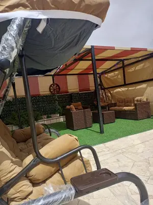 a bed in front of a tent with a boat at luxury house in Madaba