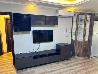 a living room with a flat screen tv on a wall at شقه في اربد apartment in irbid in Irbid