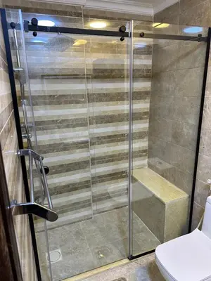 a shower with a glass door in a bathroom at شقه في اربد apartment in irbid in Irbid