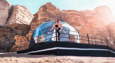a man standing on a boat in the desert at Aladdin Camp in Disah