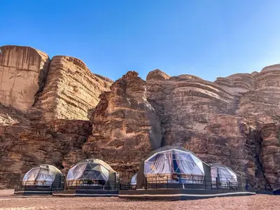 three domes in front of a rocky mountain at Aladdin Camp in Disah