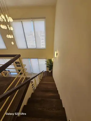 a staircase in a building with windows and a stair case at B35 Samarah Resort LOFT apartment in Sowayma