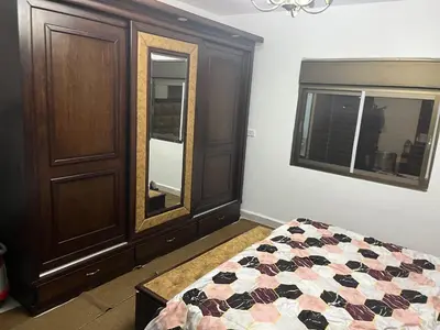a bedroom with a bed and a dresser and a mirror at منزل مستقل لقضاء اجمل الاوقات بجبال عجلون in Ajloun