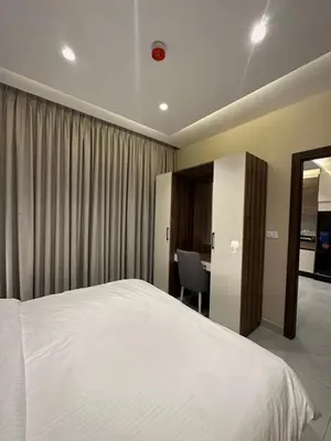 a bedroom with a white bed and a desk at Chic Apartments For Rent ave2-1 in Amman