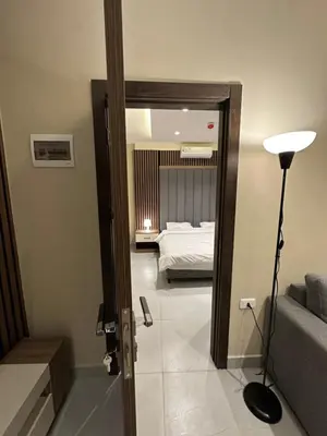 a bedroom with a bed and a door with a mirror at Chic Apartments For Rent ave2-1 in Amman