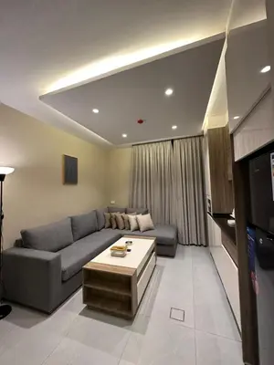 a living room with a couch and a tv at Chic Apartments For Rent ave2-1 in Amman