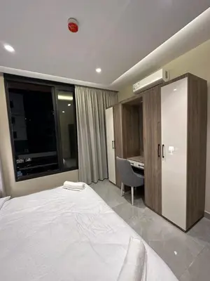 a bedroom with a bed and a desk and a window at Chic Apartments For Rent ave2-2 in Amman