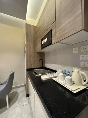 a kitchen with a black counter top in a room at Chic Apartments For Rent ave2-2 in Amman