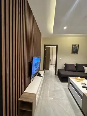 a living room with a television and a couch at Chic Apartments For Rent ave2-4 in Amman