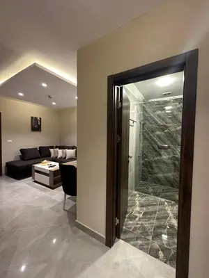 a living room with a glass shower and a couch at Chic Apartments For Rent ave2-4 in Amman