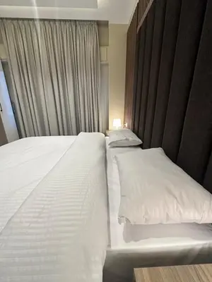 a bedroom with two beds with white pillows at Chic Apartments For Rent ave2-6 in Amman