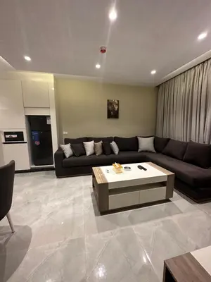 a living room with a couch and a coffee table at Chic Apartments For Rent ave2-7 in Amman
