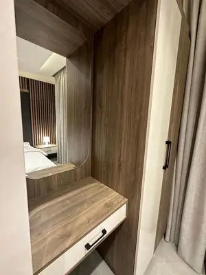 a bedroom with a bed and a wooden wall at Chic Apartments For Rent ave2-7 in Amman