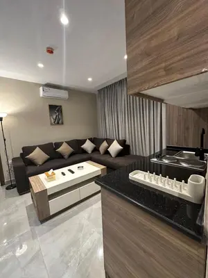 a living room with a couch and a kitchen at Chic Apartments For Rent ave2-9 in Amman