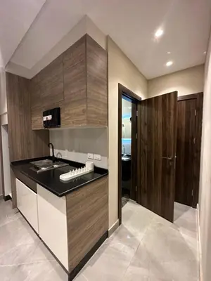 a kitchen with wooden cabinets and a sink at Chic Apartments For Rent ave2-9 in Amman