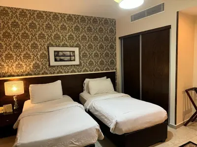 a hotel room with two beds in it at City Rose Hotel Suites in Amman