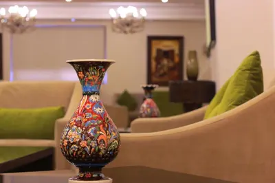 a colorful vase sitting on a table in a living room at City Rose Hotel Suites in Amman