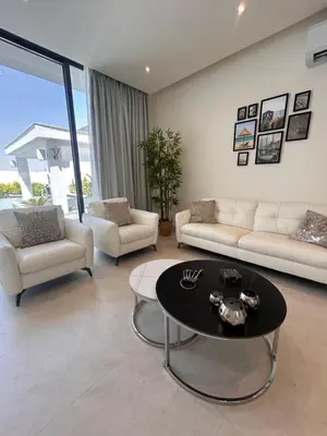 a living room with couches and a coffee table at Shomani by Seahorse in Al Rama
