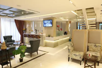 a living room filled with furniture and a tv at Londrina Hotel in Amman