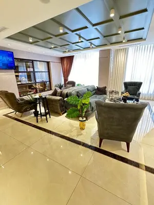 a large living room with a couch and chairs at Londrina Hotel in Amman