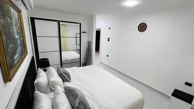 a white room with a bed and a mirror at شقة روف بعرفتين اطلالة ساحرة عمو سامي 21 in Amman