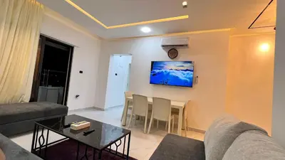 a living room with a couch and a table at شقة روف بعرفتين اطلالة ساحرة عمو سامي 21 in Amman
