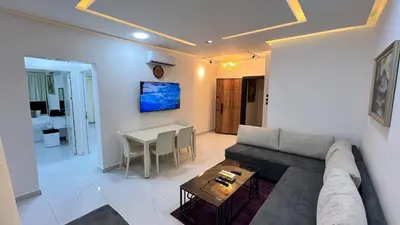 a living room with a couch and a table at شقة روف بعرفتين اطلالة ساحرة عمو سامي 21 in Amman