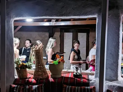 a group of people standing in front of a mirror at Desert Sand Camp in Disah