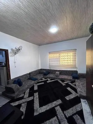 a living room with a couch and a window at olga 300 apertment in Ar Ramthā