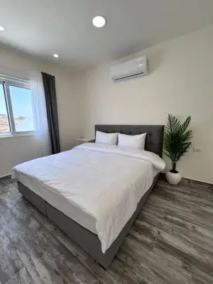 a bedroom with a large bed and a potted plant at The Greek Village - Paros By Seahorse in Sowayma