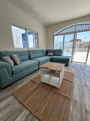 a living room with a blue couch and a coffee table at The Greek Village - Paros By Seahorse in Sowayma