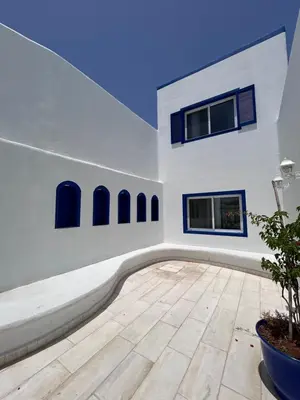 a large white room with a wooden floor and windows at The Greek Village - Cofru By Seahorse in Sowayma