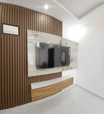 a tv on a wall in a room at شقة مفروشة بغرفتين نوم وصالة و حمامين in Amman