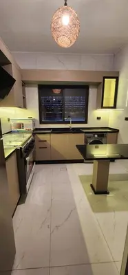 a large kitchen with a large island in a room at شقة مفروشة بغرفتين نوم وصالة و حمامين in Amman