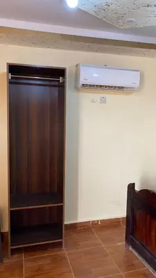 a room with a brown cabinet and a fan at Ali with the stars in Wadi Rum