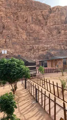 a train is parked in front of a mountain at Ali with the stars in Wadi Rum