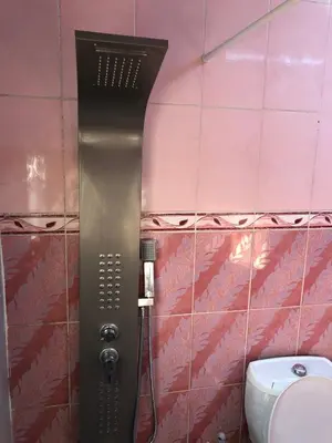 a shower in a bathroom with a toilet at Jarash in Jerash