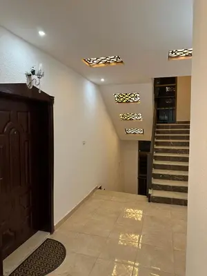 a room with a staircase and a door and a stair case at Airport Road شارع المطار in Al Yādūdah