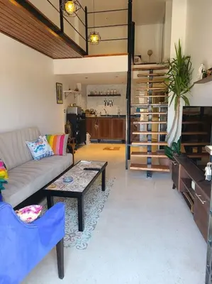 a living room with a couch and a table at Loft Apartment Jabal Amman A in Amman