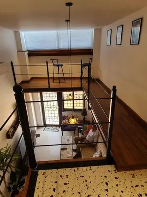 a person sitting on a couch in a living room at Loft Apartment Jabal Amman A in Amman
