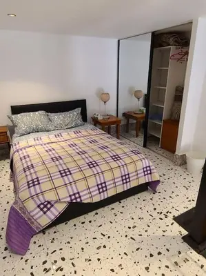 a bedroom with a bed with a checkered floor at Loft Apartment Jabal Amman A in Amman