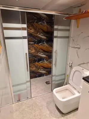 a bathroom with a shower stall and a toilet at Loft Apartment Jabal Amman A in Amman