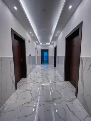 a hallway with a marble floor in a building at Petra Friends House in Petra