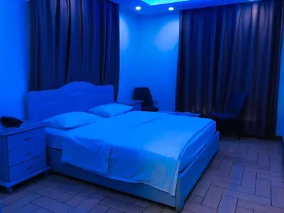 a blue bedroom with a bed with a blue light at فندق اربد بلازا in Irbid