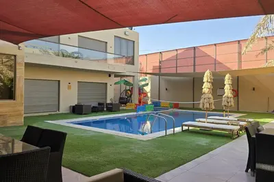a house with a swimming pool in the yard at Jumeirah Chalet جميرا شاليه in Amman