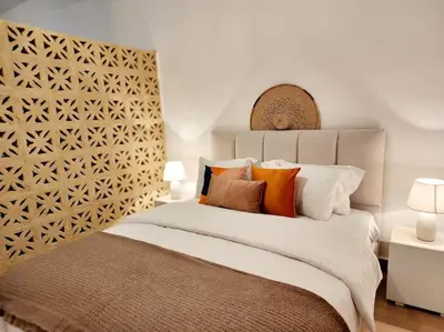 a bedroom with a large white bed with colorful pillows at Goga Apartment in Jabal Amman near Rainbow Street in Ash Shumaysānī