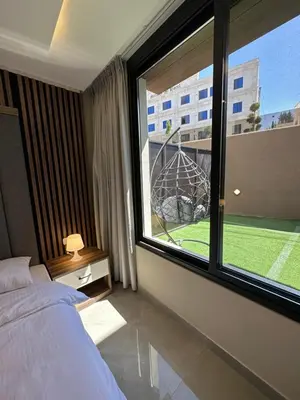 a bedroom with a bed and a large window at Chic Apartments For Rent ave0-1 in Umm Uthainah